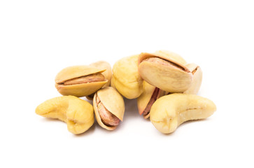 Pile of roasted pistachios and cashew isolated on white background