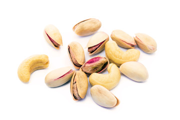 Pile of roasted pistachios and cashew isolated on white background