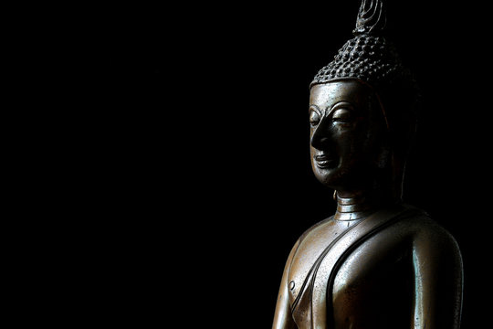 Buddha Statue on Black Background with Space for Text