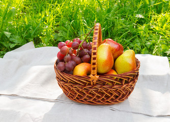 Basket with fruits on napkin
