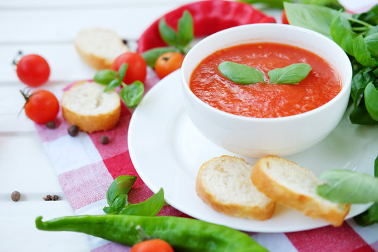 Cold summer tomato dish. Gaspacho soup with toast.