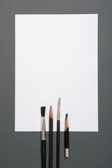 Paints brushes pencils paper colors mock up