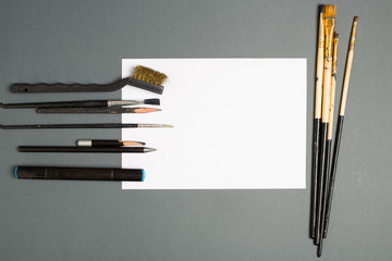 Paints brushes pencils paper colors mock up