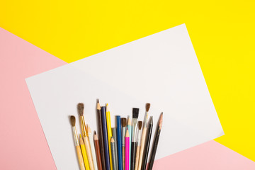 Paints brushes pencils paper colors mock up