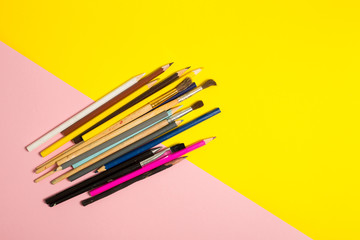 Paints brushes pencils paper colors mock up