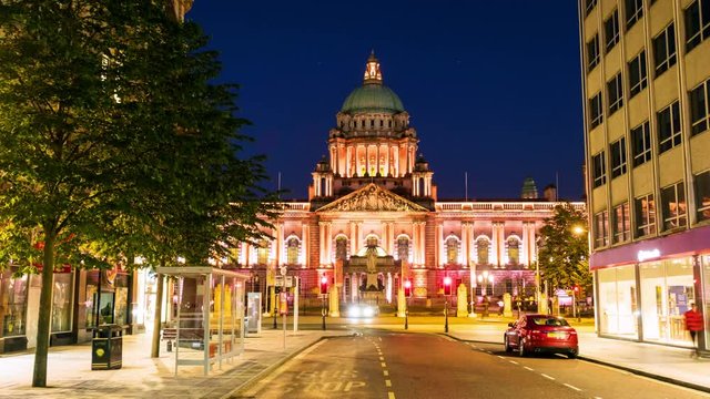 Belfast, UK. Nightlife with city hall in Belfast, UK the capital of Northern Ireland. Time-lapse of car traffic ar night with dark blue sky