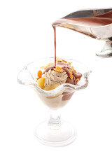 chocolate and nuts ice cream with caramel almond chips, pears and chocolate topping, exclusive summer dessert, patisserie