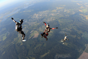 Three skydivers in the sky
