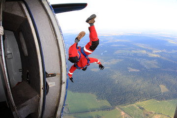 Skydiver has just jumped out of an airplane.