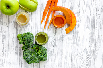 Preparing baby food. Broccoli, pumpkin, apple puree on light wooden table background top view copyspace