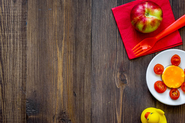 Preparing quick lunch for schoolchild. Fruits on dark wooden table background top view copyspace