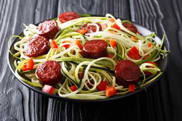 Healthy food: zucchini pasta with red pepper and natural sausages close-up. horizontal
