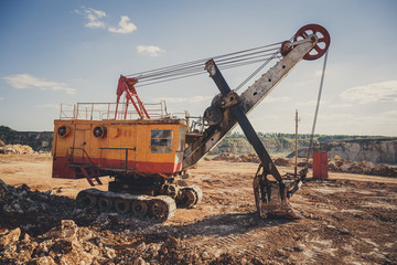 Big excavator on tracks in the quarry mining