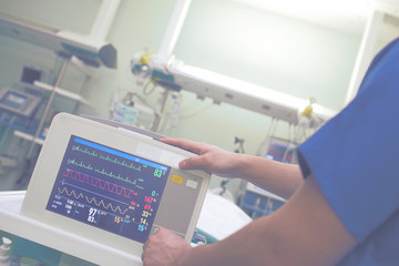 Male doctor adjusting medical equipment