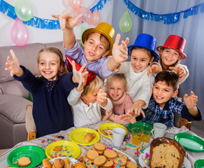 Boys and girls behaving jokingly during friend’s birthday party