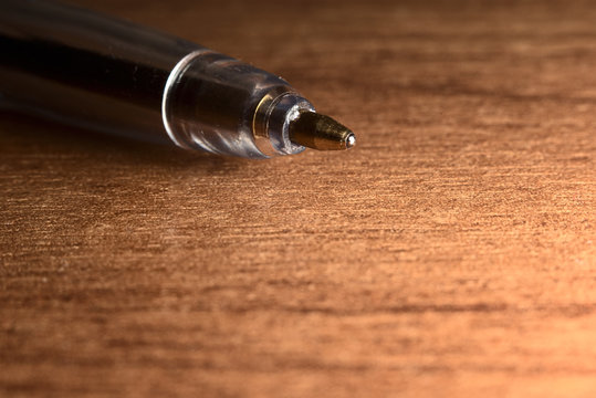 Pen on a wooden table close-up with place for text