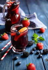 Traditional Sangria drink with red wine, tropical fruit and berries