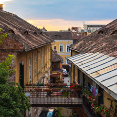 Architectural details and house roofs with attic windows designed in eyes shape in Sibiu city at...