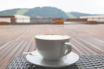 Soft focus close up cup of capuccino latte coffee on wood backgr