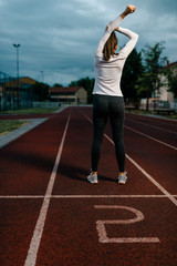 Fototapeta premium Stretching in dawn before a run