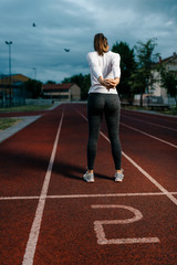 Fototapeta premium Fit woman stretching out before running