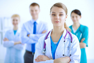 Fototapeta premium Attractive female doctor with medical stethoscope in front of medical group