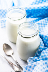 Fresh homemade greek yogurt in glass jars.