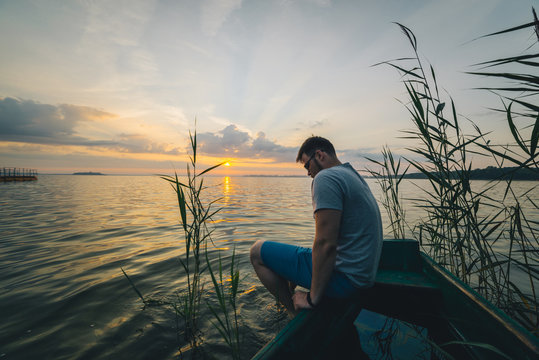 Man Sitting In The Old Boat Thinking