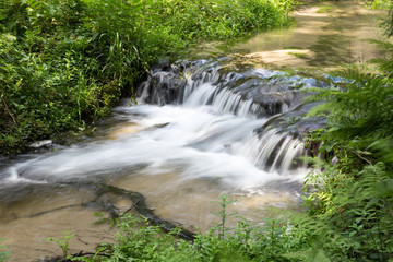 Mountain stream with stones with clear water