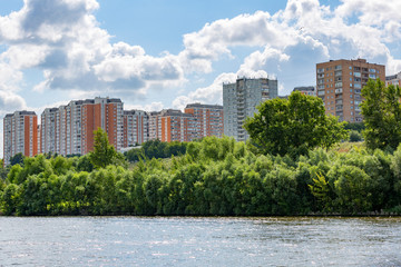 A large multi-storey building on the outskirts of the city. View from the Moscow River
