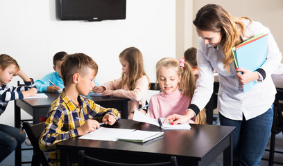 Boys and girls with teacher drawing