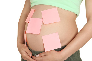 Pregnant woman with paper stickers on tummy, closeup. Concept of choosing baby name