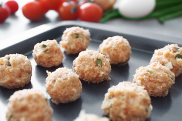 Closeup view of delicious turkey meatballs on baking tray
