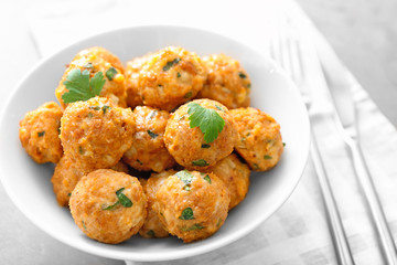 Bowl with delicious turkey meatballs on table