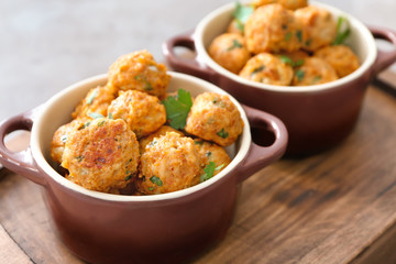 Ceramic dish with delicious turkey meatballs on wooden tray