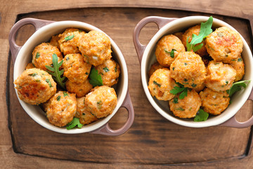 Ceramic dishes with delicious turkey meatballs on wooden tray