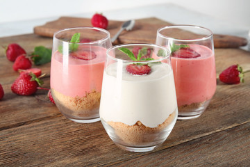 Delicious yogurt with strawberry in glasses on table