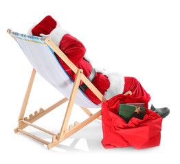 Authentic Santa Claus sitting on a beach chair against white background