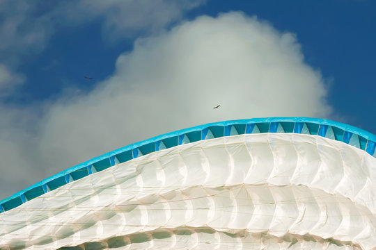 Airborne para-glider
The wing of the para-glider rises from the ground against the background of the blue sky, clouds 