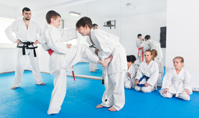 Fototapeta na wymiar Pair of boys practicing new karate moves