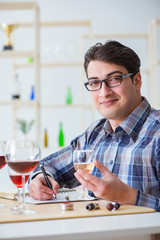 Professional sommelier tasting red wine 