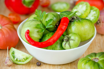Fresh vegetables - green tomatoes, red hot pepper, parsley, garlic and spices