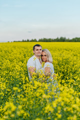 Naklejka na ściany i meble Young couple in a yellow field