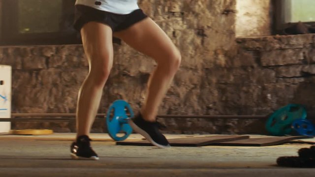 Fit Athletic Woman Does Footwork Running Drill in a Deserted Factory Remodeled into Gym