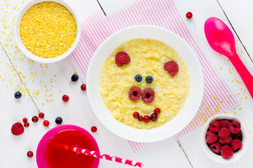 Milk corn porridge for kids healthy breakfast shaped cute pig, creative idea for baby meal