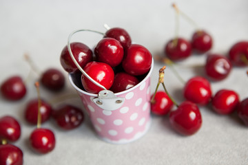 Red cherries in little pink bucket
