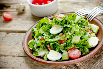 Salad with cherry tomatoes and quail eggs