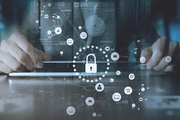 cyber security internet and networking concept.Businessman hand working with VR screen padlock icon on computer background