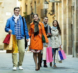 Group of young tourists with purchases