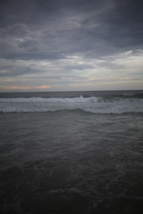 Ocean with Crashing Waves under a stormy sky at dusk